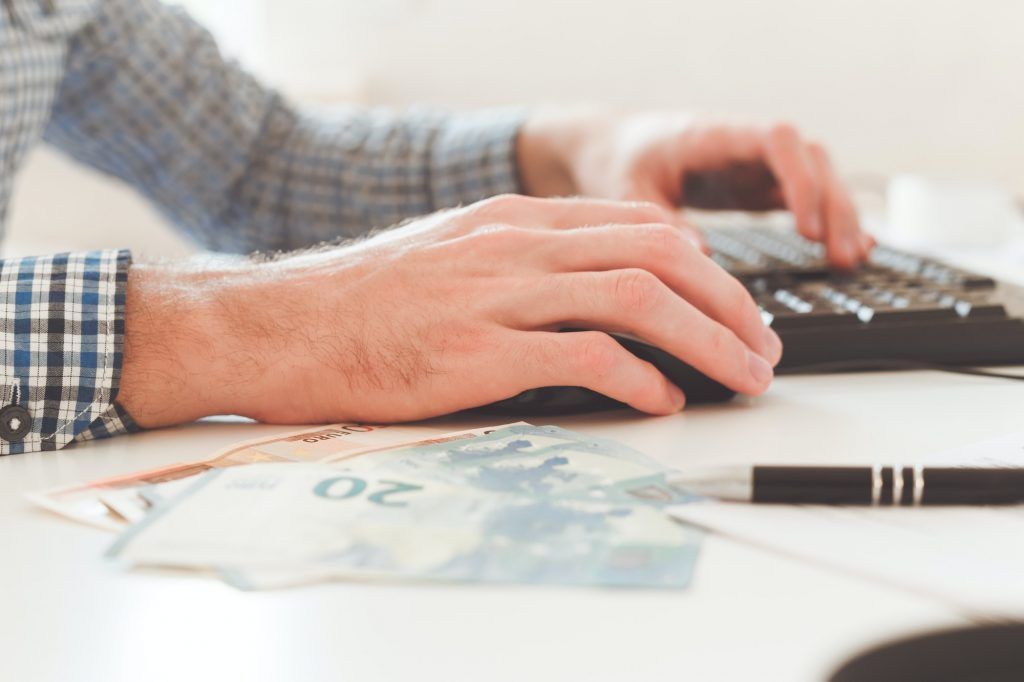 Office work. Businessman work on computer with finances. Blurred background, film effect