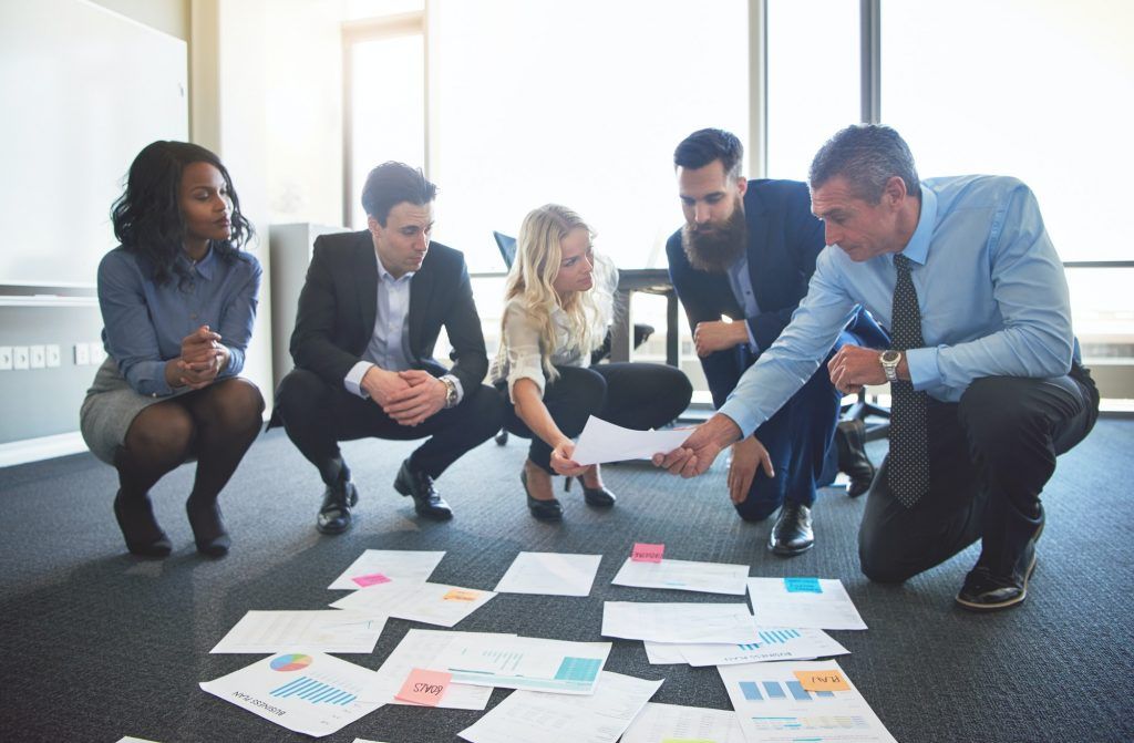 Workers looking at ideas in office